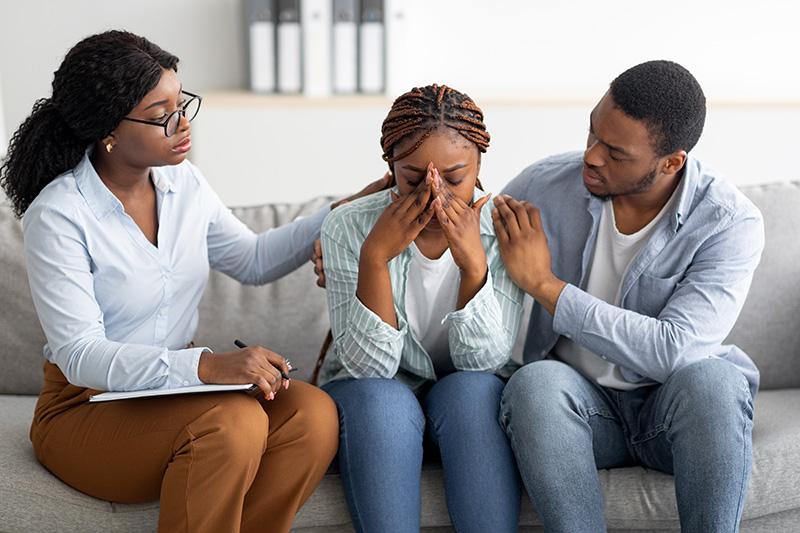 Therapist supporting a patient and family member during depression care